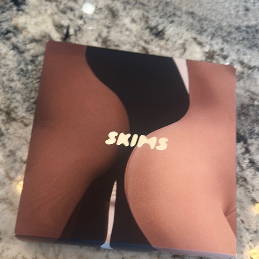 SKIMS butt enhancing shape wear open busy bodysuit